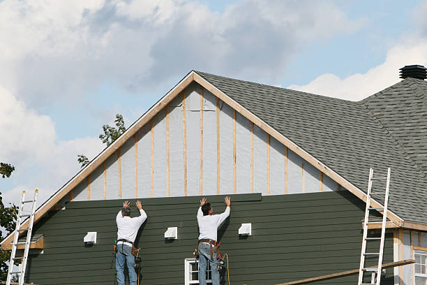 Professional Storm Damage Siding Repair technician working in Fairview, NY